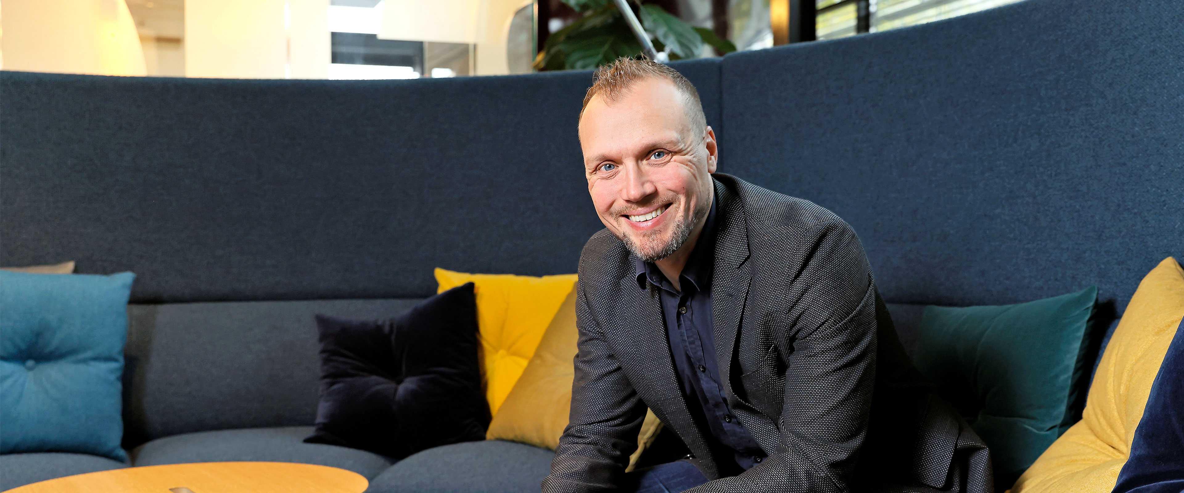 Martela's CEO Artti Aurasmaa sitting on a sofa